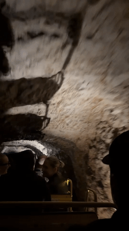 Cave tour train carries tourists through Slovenia underground formations