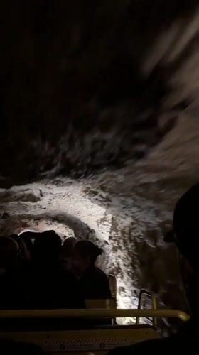 Cave tour train carries tourists through Slovenia underground formations