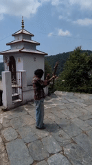 Person observed at small temple structure in Haini, India