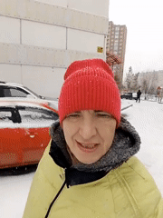 Woman in winter clothing observed during snowfall in Krasnoyarsk