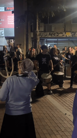 Street drummers perform nighttime show in Barcelona
