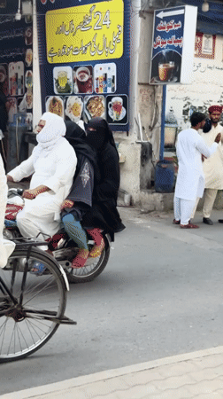 Man on homemade cart observed during street traffic in Multan