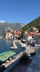 Sunny morning views over Perast's calm bay and waterfront