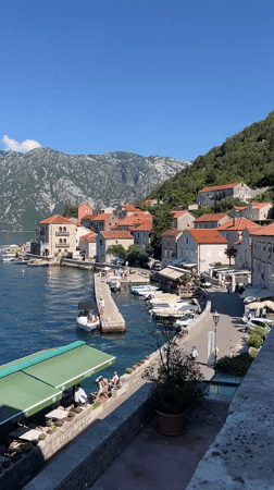 Sunny morning views over Perast's calm bay and waterfront
