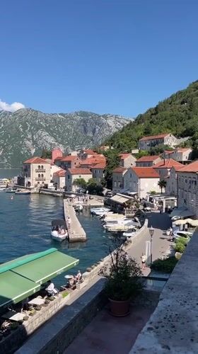 Sunny morning views over Perast's calm bay and waterfront