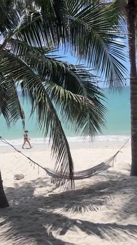 Woman walks tropical beach in Vietnam coastal scene