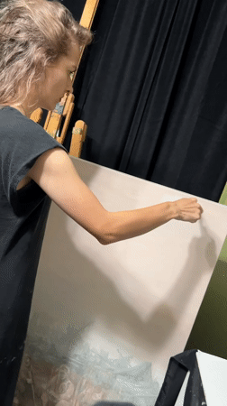 Artist works on large painting in Cape Coral studio