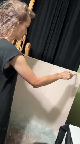 Artist works on large painting in Cape Coral studio