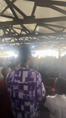Formal community event with speeches and large crowd in Itoga, Nigeria