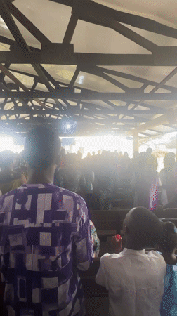 Formal community event with speeches and large crowd in Itoga, Nigeria