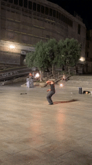 Fire dancing and skating outside Barcelona Cathedral at night