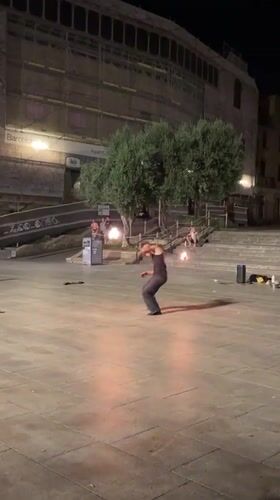 Fire dancing and skating outside Barcelona Cathedral at night