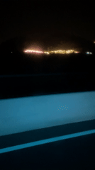 Night drive through rural Vietnam captures distant town lights