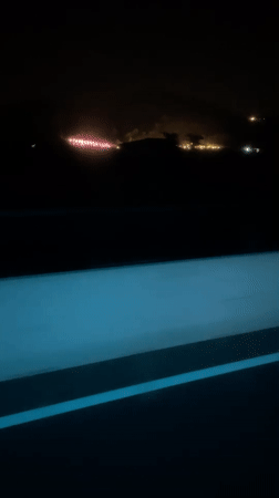 Night drive through rural Vietnam captures distant town lights