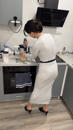Woman cooking with electric mixer in Murino kitchen