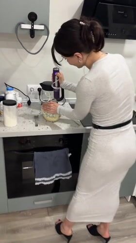 Woman cooking with electric mixer in Murino kitchen