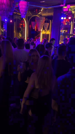 Late-night Milan club scene with neon lights and Dom Perignon