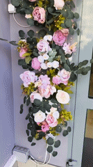 Woman poses at flower-decorated storefront in Khimki, Russia