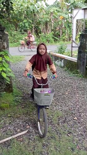 Student with bicycle observed in Baron, Indonesia residential area