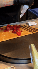 Food worker prepares crepe dessert in Zapopan restaurant