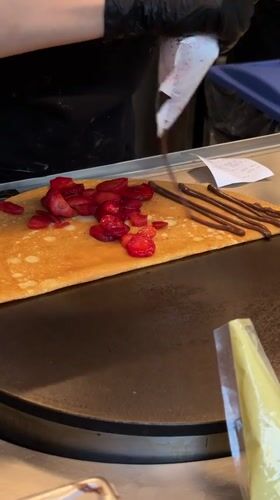Food worker prepares crepe dessert in Zapopan restaurant