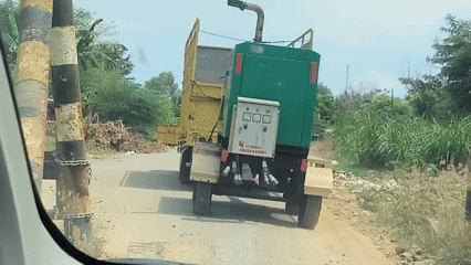 Truck transports generator on dirt road in Lhokseumawe
