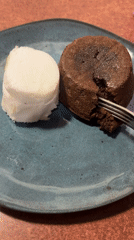 Chocolate lava cake cut revealing molten center with ice cream