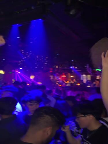 Nightclub scene with colorful lights captured in Xuanwu District