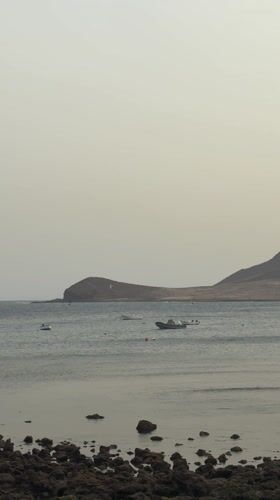 Peaceful coastal scene with boats captured near Granadilla, Spain