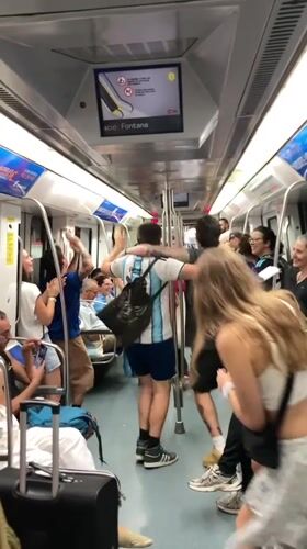 Barcelona fans celebrate on the metro after a match