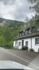 Car travels rural road near Beuron, Germany