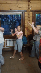 Women dance in cabin while fire burns outside