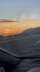Driver captures coastal sunset views on Montenegro road