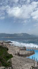 Rough seas batter Montenegro coastline under cloudy skies