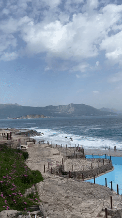 Rough seas batter Montenegro coastline under cloudy skies