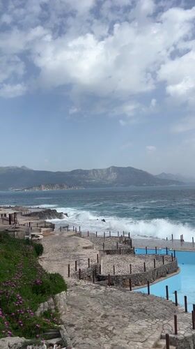Rough seas batter Montenegro coastline under cloudy skies