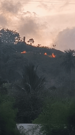 Hillside fire and everyday life around Lhokseumawe, Indonesia