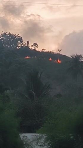 Hillside fire and everyday life around Lhokseumawe, Indonesia