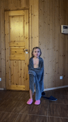 Family explores lakeside area with cabins and rocky terrain