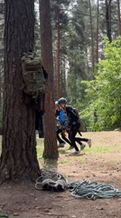 Three helmeted youths engage in forest activity near Chaikovsky