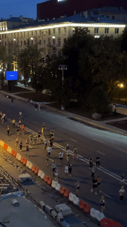 Evening run through a tree-lined Moscow street with construction barriers
