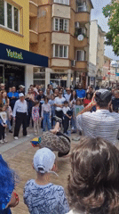 Street performer breakdances for diverse crowd