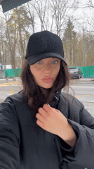 Woman records self-video near signage in Krasnogorsk
