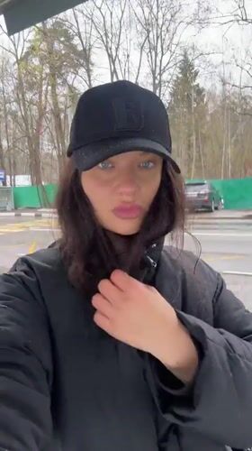 Woman records self-video near signage in Krasnogorsk