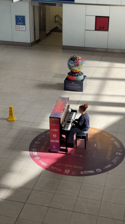 Piano performance and transport activity at London underground station