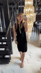 Woman takes selfies near crystal chandelier in Moscow building