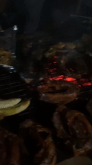 Meat grilling at a nighttime street market in Nyanya, Nigeria
