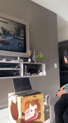 Young gamer plays racing video game in Buenos Aires