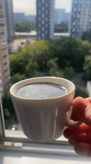 Hot coffee by the window, steam rising from a white mug.