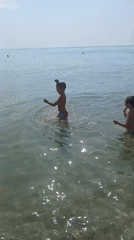 Calm summer morning at Kranevo beach, kids in the shallows